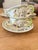 Charming set of five vintage French Longchamp faience cups with matching saucers, each hand-painted in soft, earthy tones...