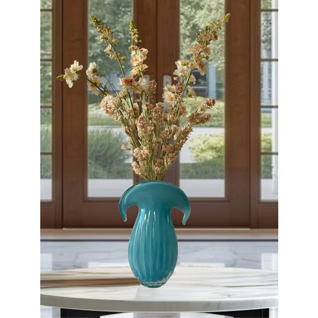 Crafted in the style of Archimede Seguso, this vintage Murano art glass vase features a distinctive flared and curled rim...