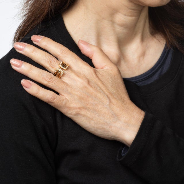 Vintage "C de Cartier" diamond ring crafted in 18k yellow and white gold (circa 1997). 22 diamonds adorn the double C...