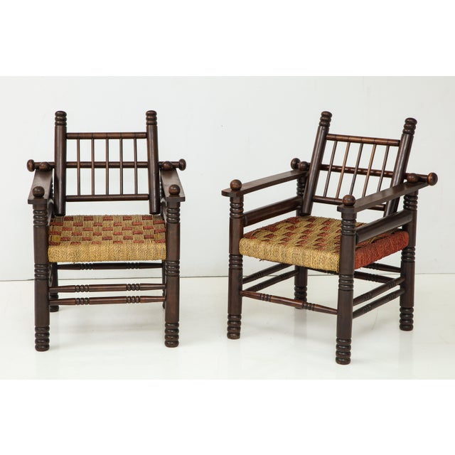 Unusual pair of spindle back armchairs with woven seats.