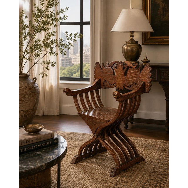 An exceptional 19th-century Anglo-Indian Savonarola-form armchair, richly decorated with intricate metal inlay and...