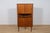 This corner teak chest of drawers was manufactured in Denmark in the 1960s. The chest of drawers features sliding doors,...
