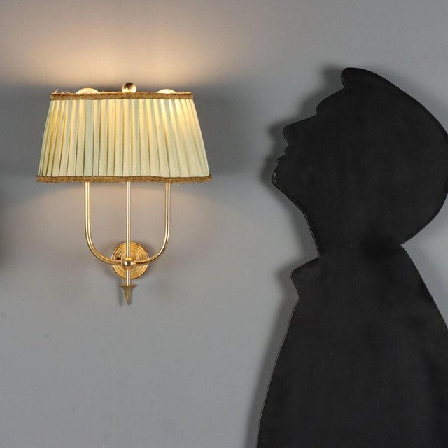 Italian-made wall lamps dating back to the 1940s and 1950s, featuring a brass frame that lends a classic aesthetic. The...