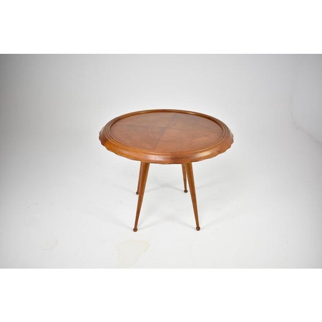 A vintage Italian side table attributed to Paolo Buffa, dating to the 1950s. The circular top is finished with a finely...
