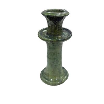 A Moroccan Tamegroute glazed candlestick holder is a handcrafted piece made in the historic pottery village of Tamegroute...