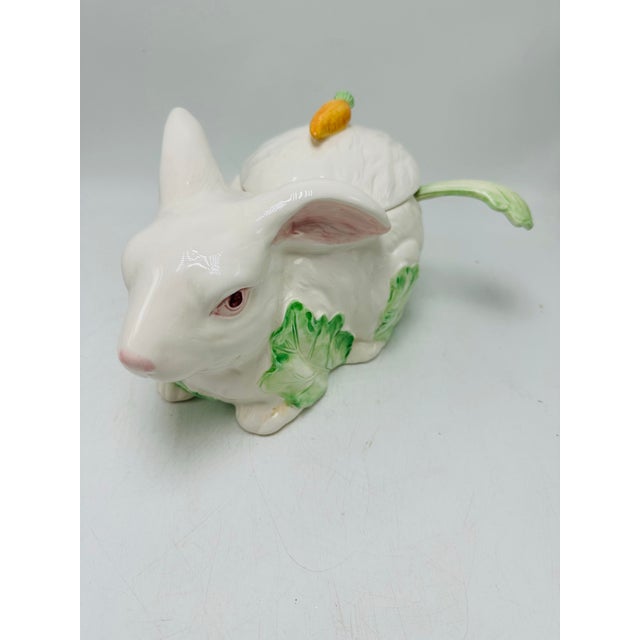 This is a vintage ceramic rabbit-shaped tureen made in Japan. Description: A glossy white ceramic bunny serves as the...