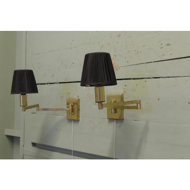 A Pair of Brass Swing Arm Wall Lights Great pieces for any room but especially the bedroom, they can easily swing out to...