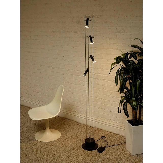 A striking vintage floor lamp with a tall, architectural profile and an ingenious system of individually adjustable...
