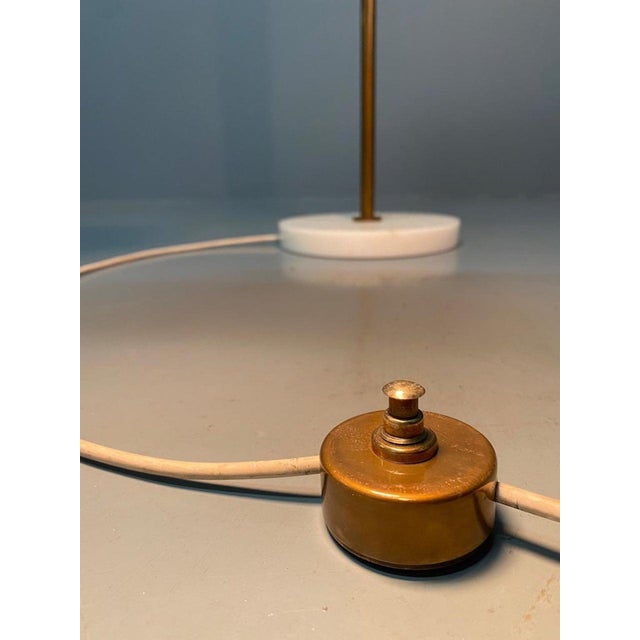 Gorgeous, minimalist, adjustable floor lamp, model 339, designed by Giuseppe Ostuni and produced by Oluce (Italy, 1950)....