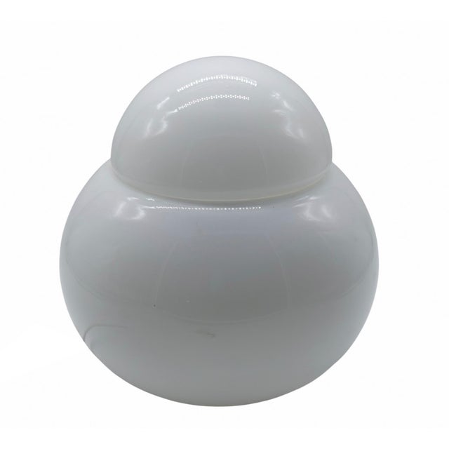 Small “Daruma” table lamp designed by Sergi Asti in 1969 for Fontana Arte, made from a spherical hand-blown opal glass...