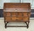 This circa 1900 oak secretary desk features a fall-front writing surface framed by bold geometric moldings and...