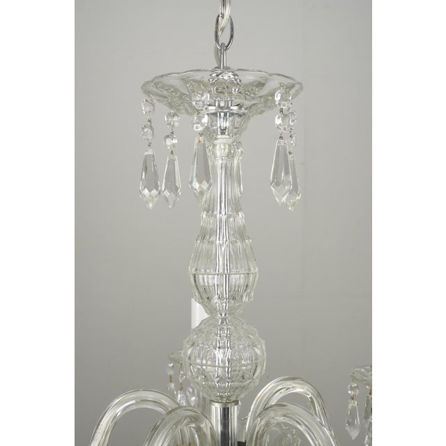 Vintage Art Deco crystal chandelier with glass arms, bobeches, and crystal drops. There are faceted glass beads and...