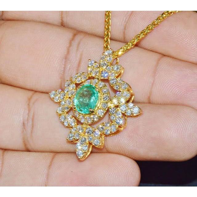 Gorgeous GIA certified natural emerald and diamond pendant. Pendant has a stunning diamond studded floral / leaves design...