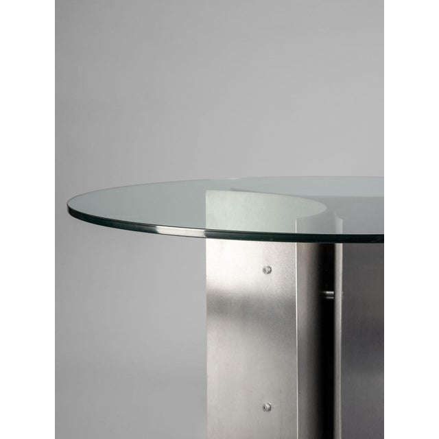 Round dining table by Michel Boyer, in brushed steel and glass; France, early 1970s. Michel Boyer (1935–2011), from 1957...