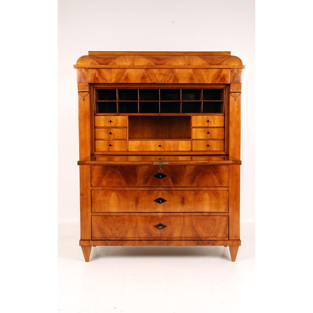 Elegant secretary desk with superb cherry wood grain on the front, veneered headboard, crescent-shaped panel on the...
