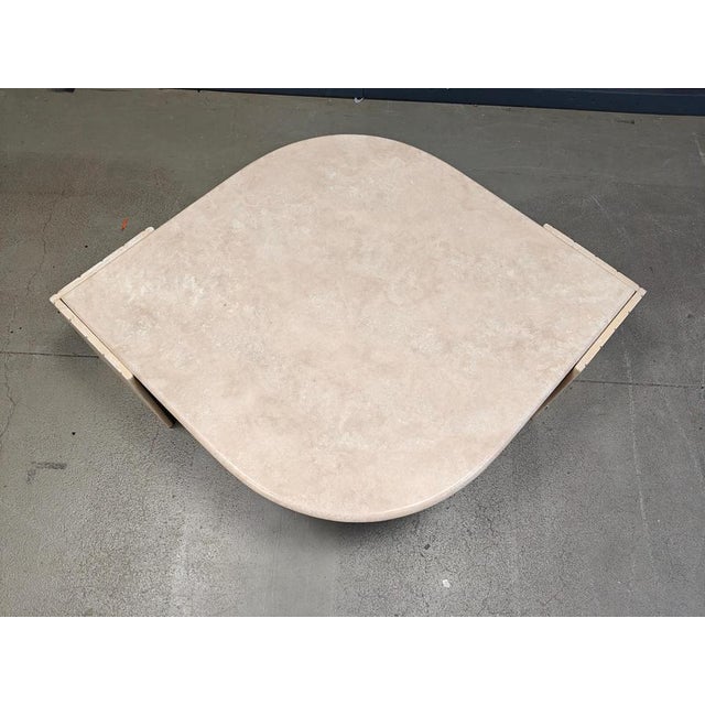 Gorgeous travertine 'eye' shaped coffee table by Roche Bobois. These tables have been popular thanks to their curved and...