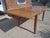 A superb 1950s solid oak dining table, a testament to the craftsmanship of french cabinetmaking in the post-war era. Its...