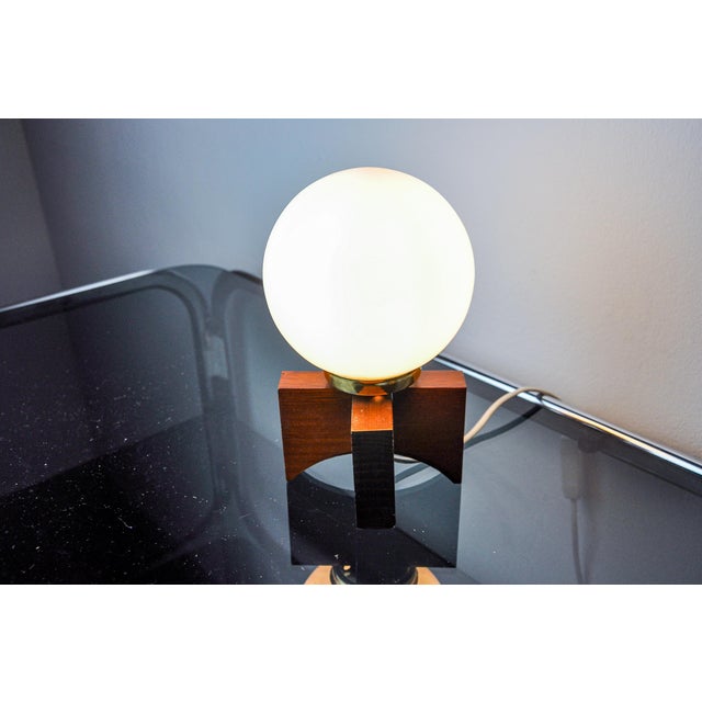 Very beautiful little table lamp designed and produced in Spain in the 1970s. Pine structure supporting an opaline glass...