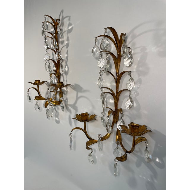 A fabulous pair of Italian Gilded Tole Two-Arm Candle Sconces with 20-22 eye catching large 2" crystal prisms on each...