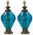 This is a beautiful pair of Hollywood Regency Era blue glass and brass table lamps. The wiring is good and features a...