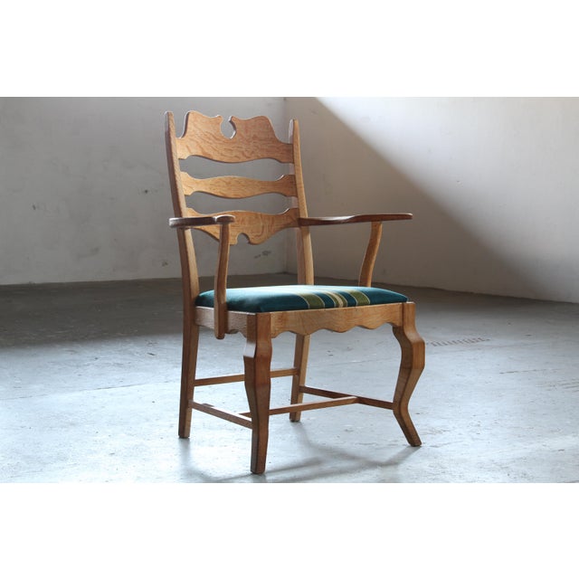 Presenting this wonderful pair of Henning Kjærnulf brutalist oak armchairs, in the iconic "razorback throne" style,...