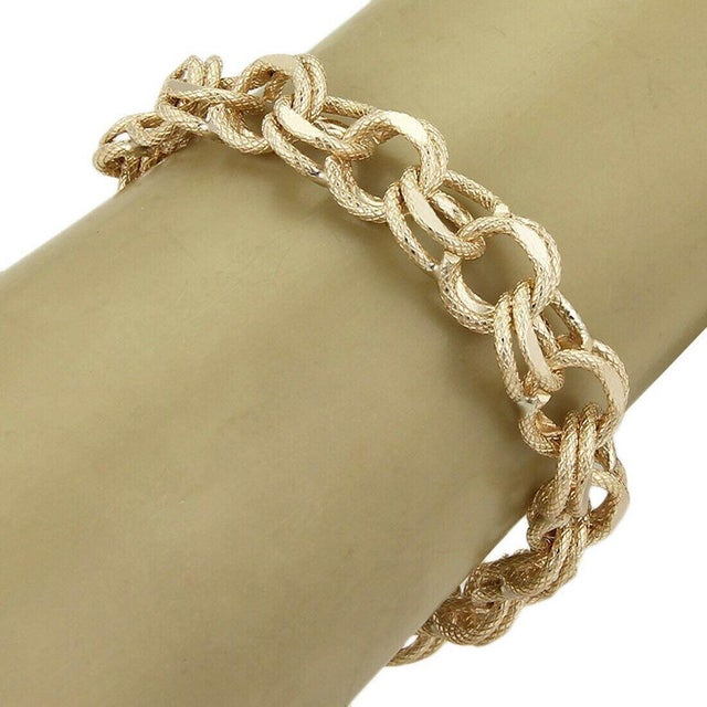 This Textured Double Round Link Bracelet is a stunning vintage piece of fine jewelry, expertly crafted in solid 14k yellow...