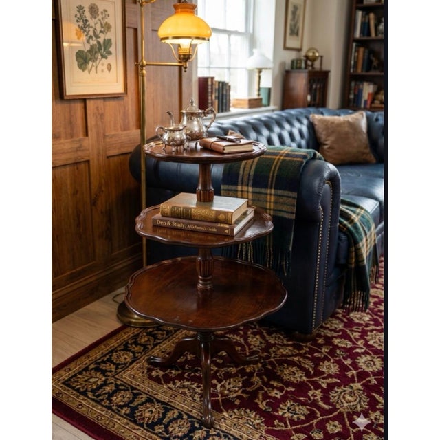 This elegant Mid-Century Mersman Furniture three-tiered dumbwaiter accent table perfectly captures classic Georgian and...
