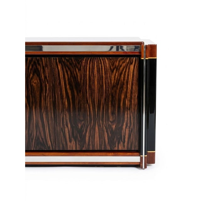 An elegant Hollywood Regency-style sideboard dating back to the late 1970s/early 1980s. Finely lacquered with a rosewood...