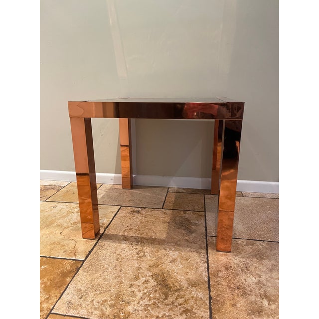 This 1960's Mid-Century Modern Side Table is meticulously constructed with copper glazed metal frame and dark brass...