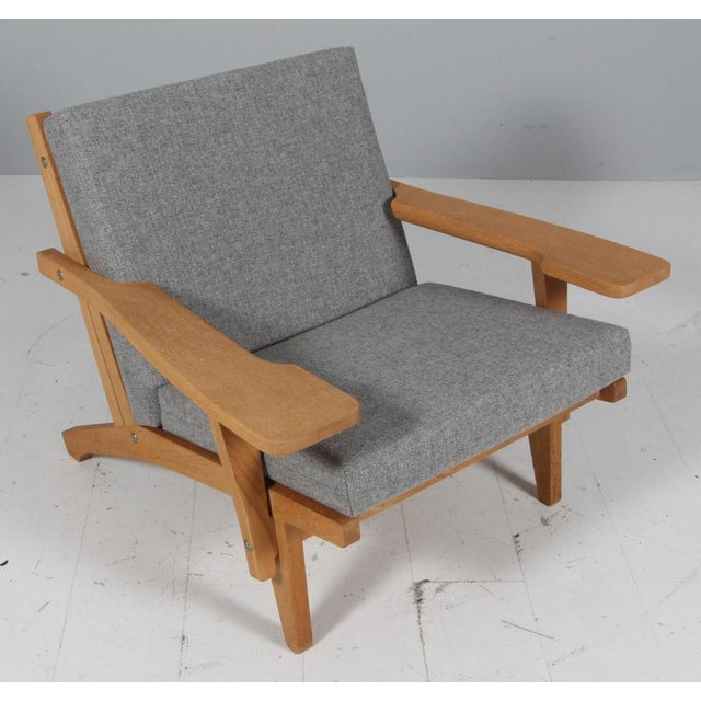 Hans j. Wegner lounge chair with loose cushions new upholstered with hallingdal wool from kvadrat frame of oak. With...