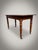 Constructed in England circa 1880, this 19th-century side table presents a well-figured flame mahogany top set above an...