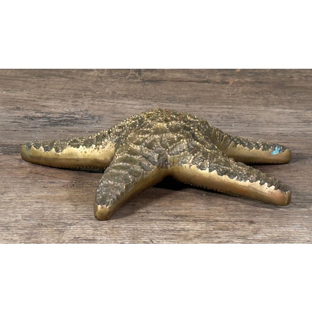 Vintage brass starfish decorative object with raised textured detailing and a natural aged patina, dating to the mid 20th...