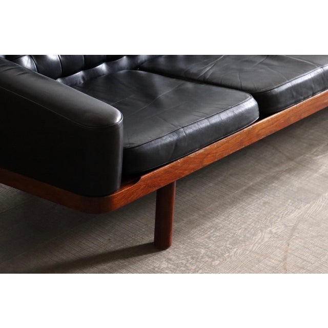 Sophisticated sofa designed by arne halvorsen, executed in black leather and hardwood frame, produced in norway in the...