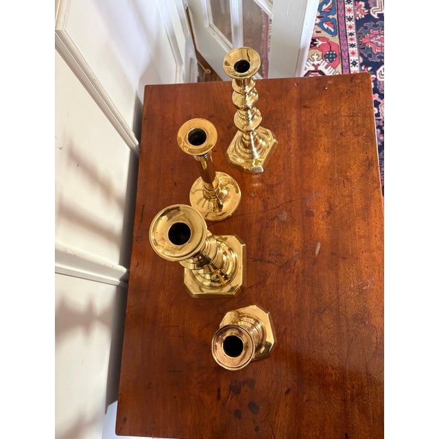 Group of Four English Polished Brass Candlesticks Different Sizes, 19th Century Sizes: 4.75" x 4.75" x 12.75" 3.75" x...