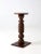 This antique American wood pedestal stand features a turned baluster column and a round top. Its classic silhouette makes...