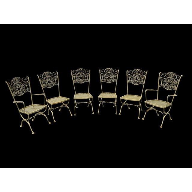 A highly desirable set of six Woodard Andalusian Collection wrought iron dining chairs, designed circa 1960s–70s. Each...