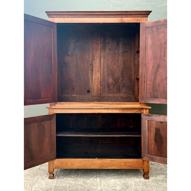 Exude the quiet charm of a European estate with this magnificent vintage wood panel cabinet. A masterclass in French...