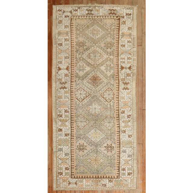 Warm colors set the tone for this Early 20th-century Kurdish Tribal Runner circa 1910. Measures: 3'6" x7'2".