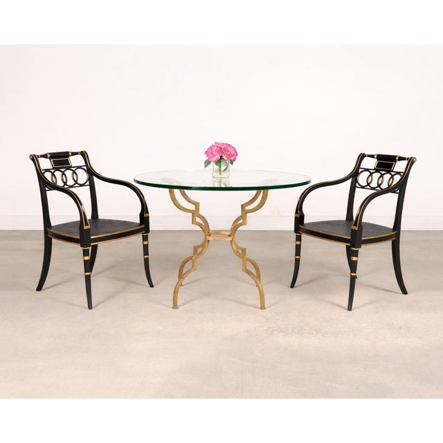 A sculptural French Hollywood Regency breakfast dining or center table in the style of Maison Jansen. The design pairs an...