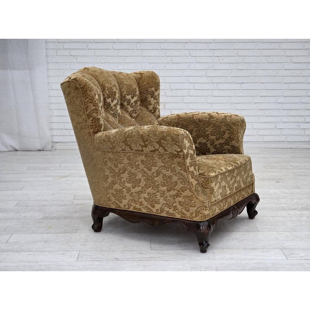 1950s, Danish relax armchair. Honey-yellow furniture velour, carved oak wood, brass springs in the seat. Original good...