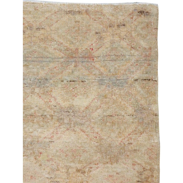 This mid-20th-century Turkish Anatolian square rug presents a softly layered geometric composition in pale sand, warm...