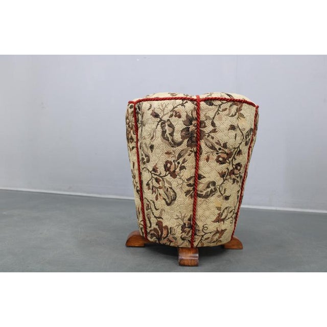 Elegant Art Deco upholstered stool produced in Czechoslovakia during the 1930s. The piece features a robust wooden...