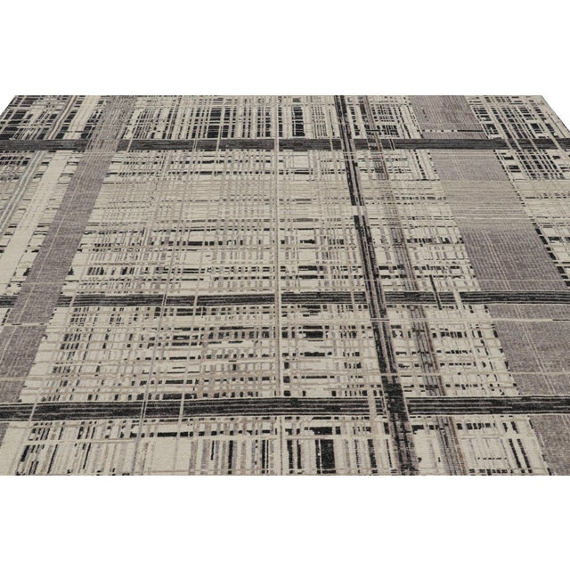 Hand-knotted in wool, this 9x12 modern rug, originating from India, as inspired by modern art with an abstract pattern, is...