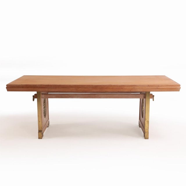 A bold dining table crafted from mahogany with striking bronze accents, in the distinctive style of James Mont, circa...