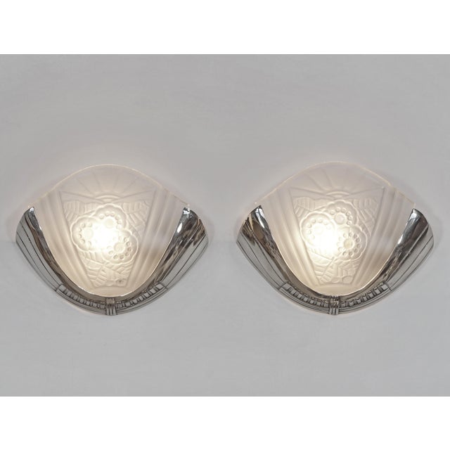 G. VIARMÉ A beautiful pair of 1925-1930 French art deco wall sconces in nickel plated solid brass or bronze holding two...