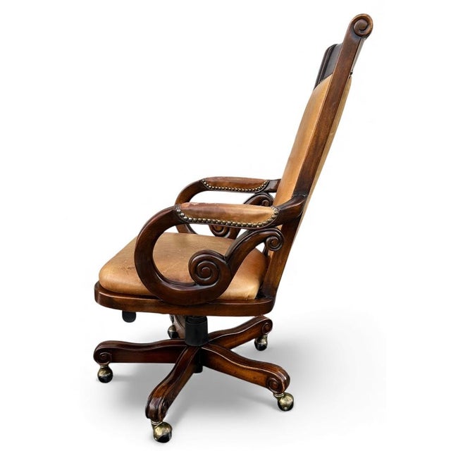 Vintage Bradington Young executive chair with leather seat and back and nailhead detail Wood Frame and Roller wheels. Wood...