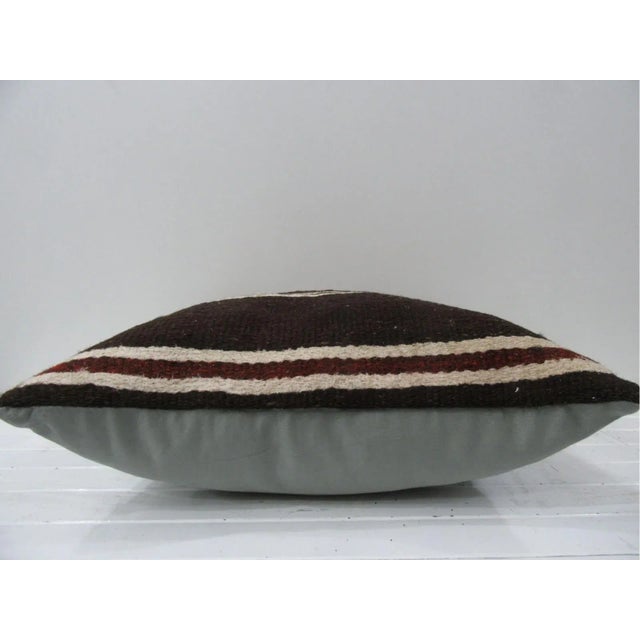 This is a pillow cover made from a vintage kilim rug. The piece was properly washed and ready to use. Pillow inserts not...