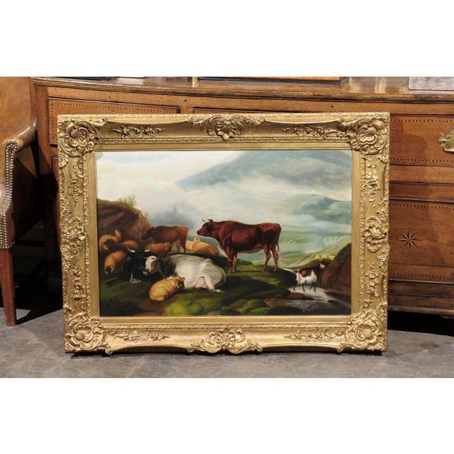 A large size English late 19th century framed pastoral oil painting depicting cattle, sheep and goat in a landscape. The...