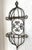 This is a vintage wrought iron wall planter with hanging rings at the top and bottom. The dark metal has a soft rust...