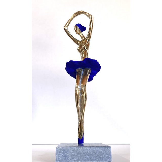 This shiny contemporary bronze sculpture of a ballerina blends elegance with a playful, whimsical spirit. Slightly...
